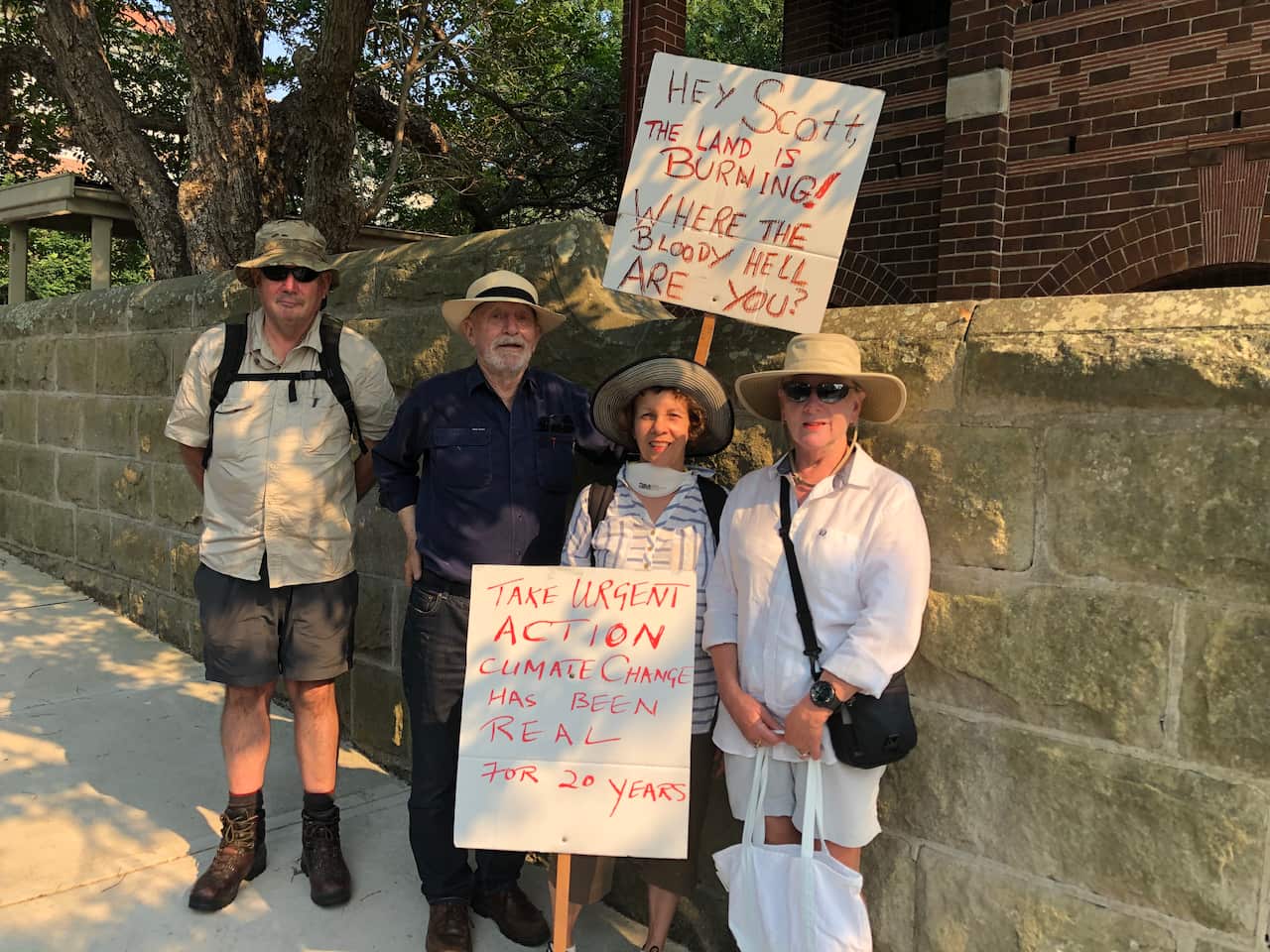 Protesters hold signs asking Scott Morrison "where the bloody hell are you?"