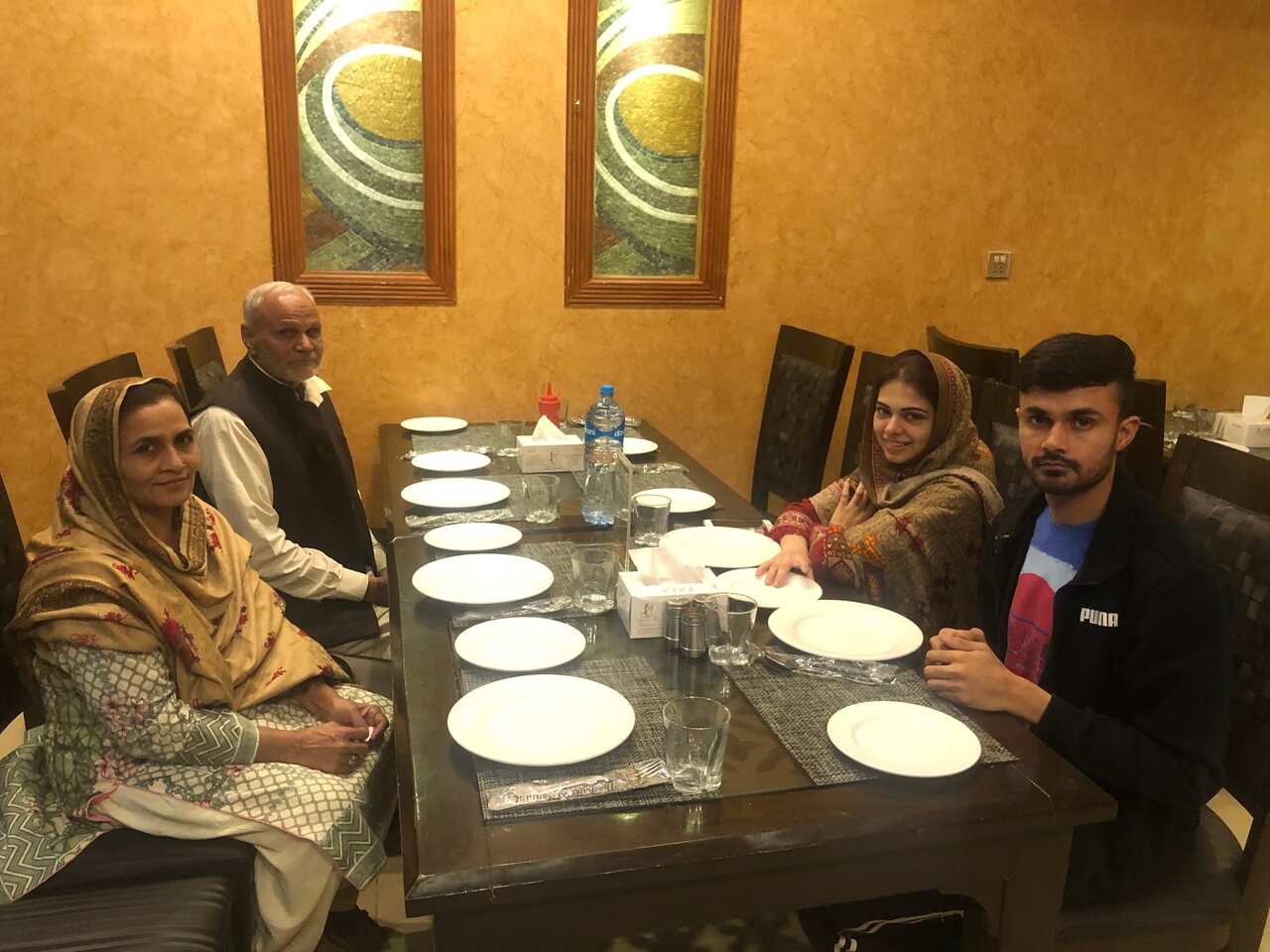 Haroon Iqbal (right) with his mother and father (left) 