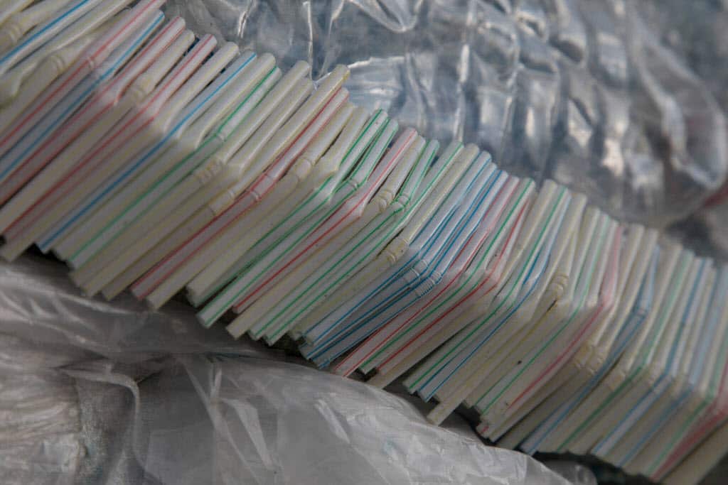 Close up of plastic straws aimed to encourage people to take action against single use plastics.