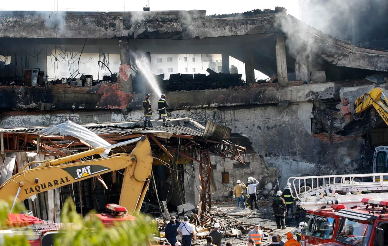 Firefighters work at the site where a TAM airlines jet crashed in Sao Paulo