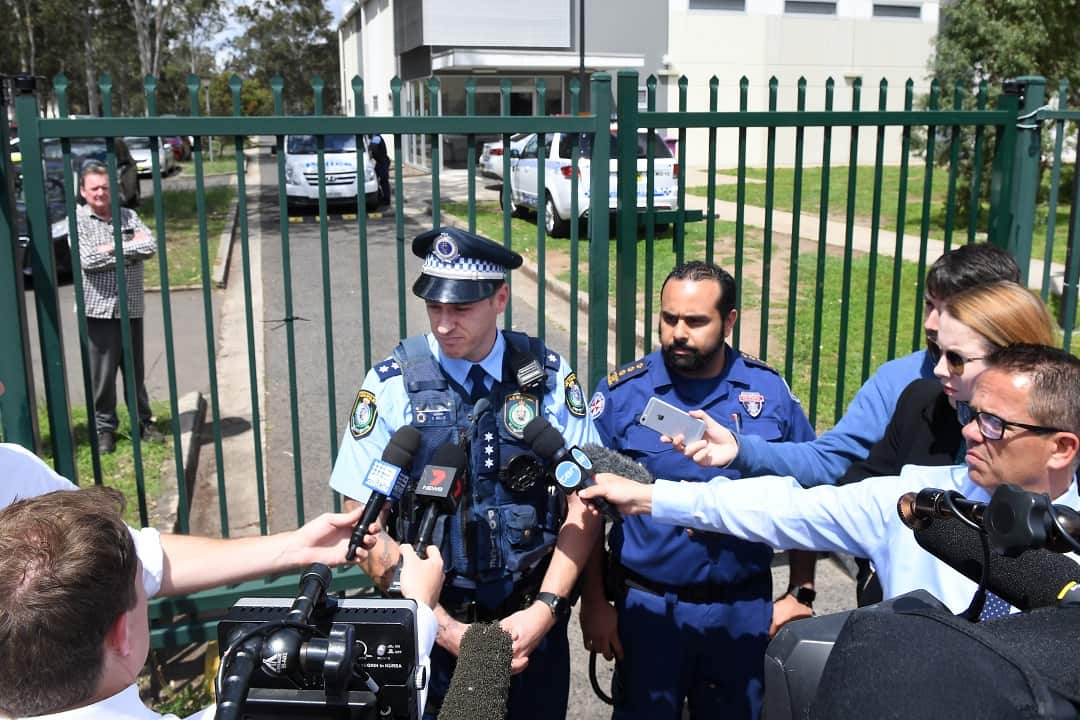 Acting Inspector Shane Rolls speaks to the media alongside NSW Ambulance's Joe Ibrahim following the incident at Plumpton High School.