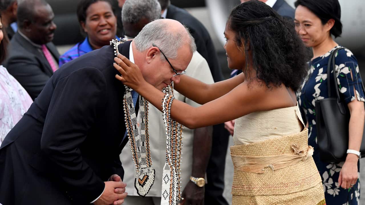 Australian Prime Minister Scott Morrison (left) is seen being greeted after arriving at Honiara International Airport.
