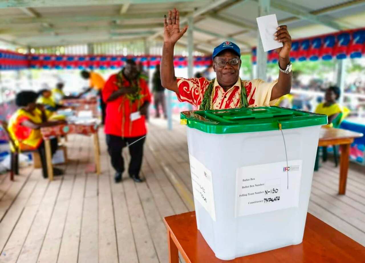 A man raises his hands as he prepares to cast a vote in Buka, the Autonomous Region of Bougainville.
