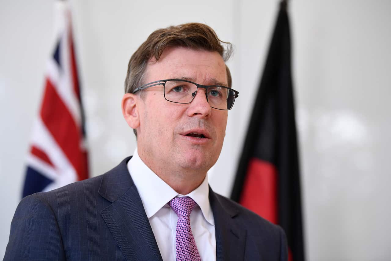 Alan Tudge wearing a suit and glasses.