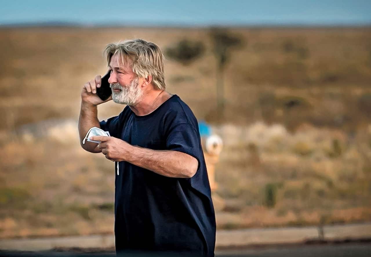 Alec Baldwin speaks on the phone outside the Santa Fe County Sheriff's Office, after he was questioned about a shooting on the set of the film Rust.