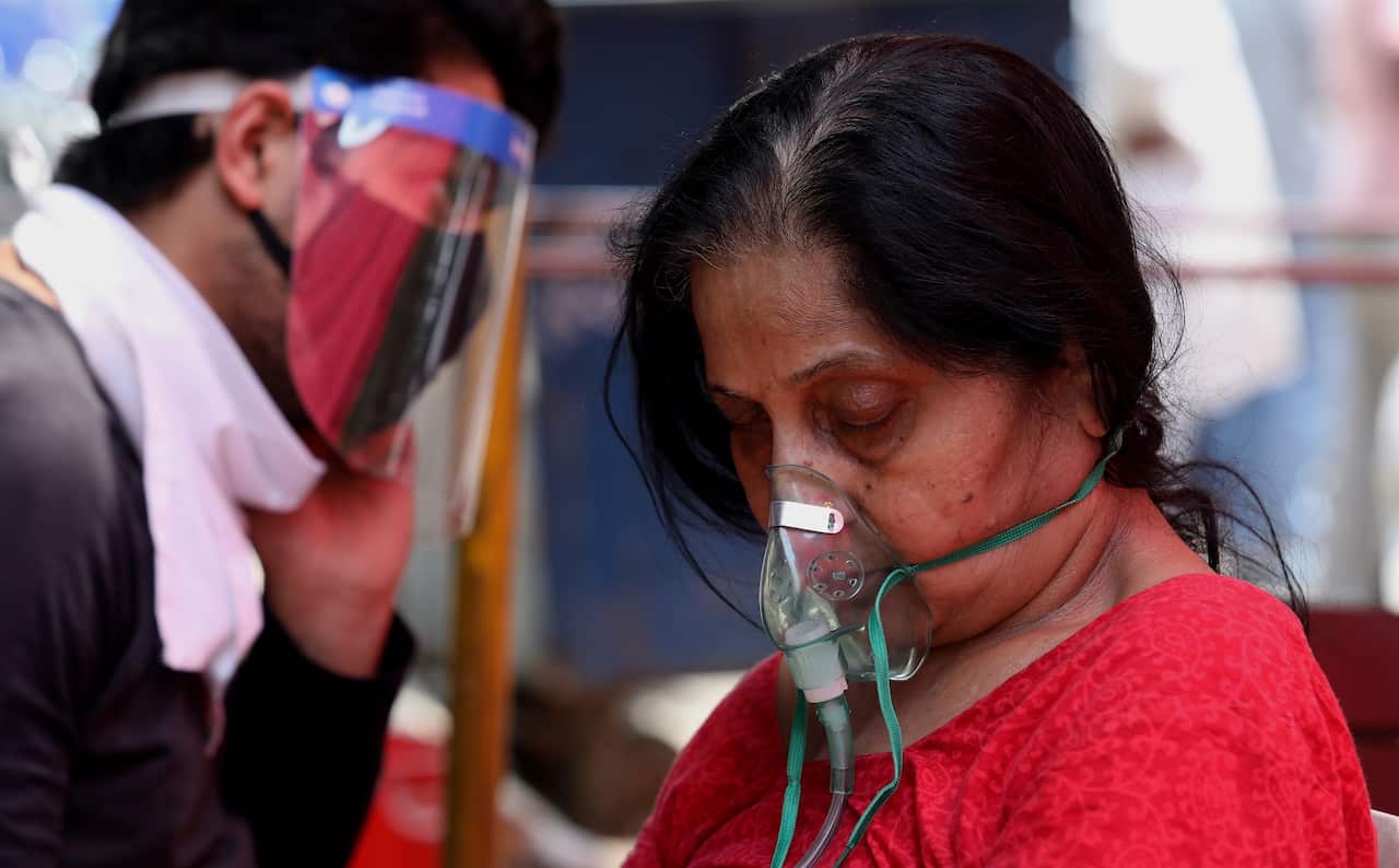 A woman in India wearing an oxygen mask