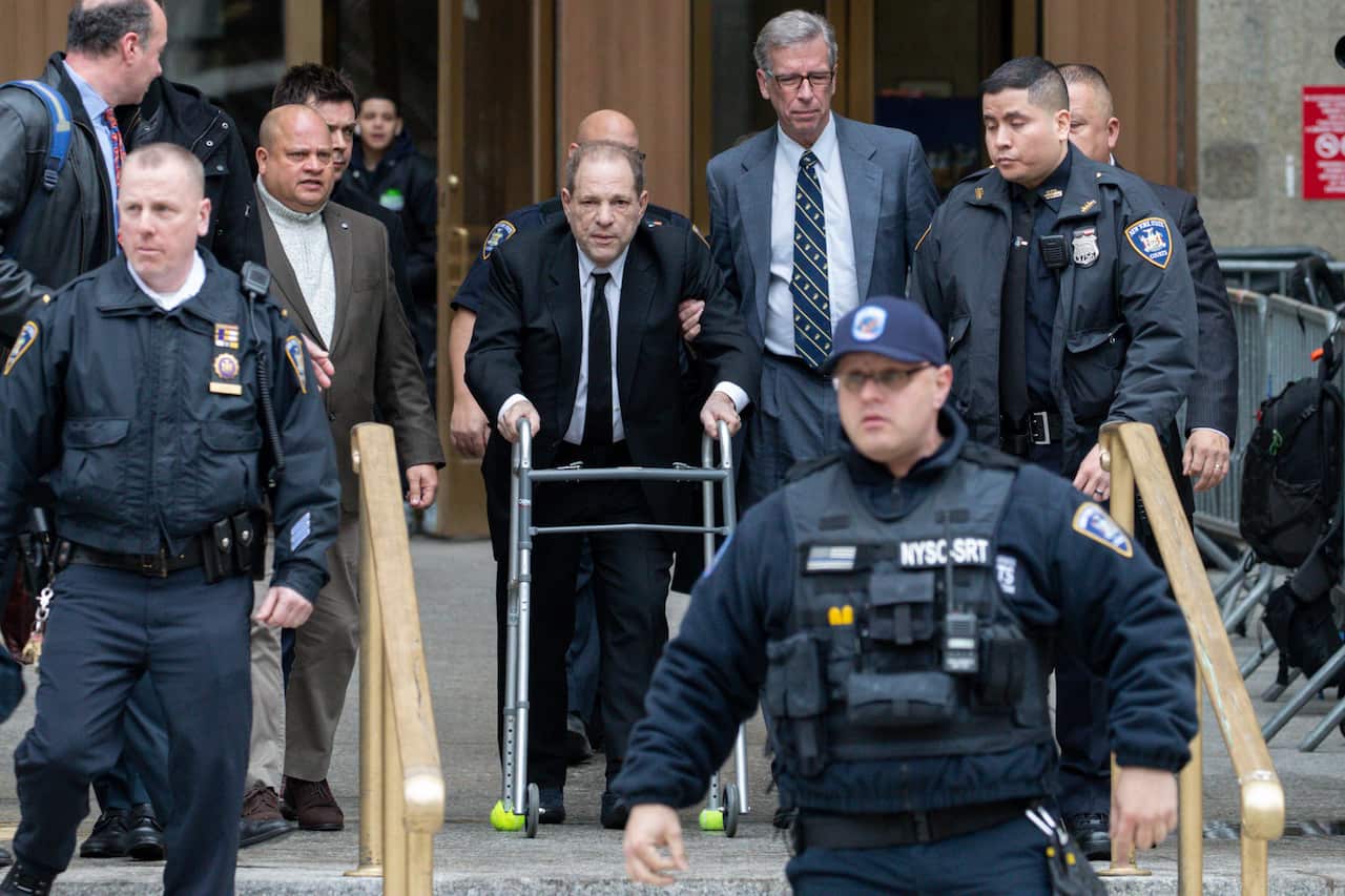 Harvey Weinstein (centre) surrounded by court officers during an earlier hearing. 