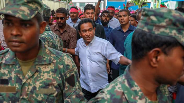 Maldivian president Yameen Abdul Gayoom, center, surrounded by his body guards .