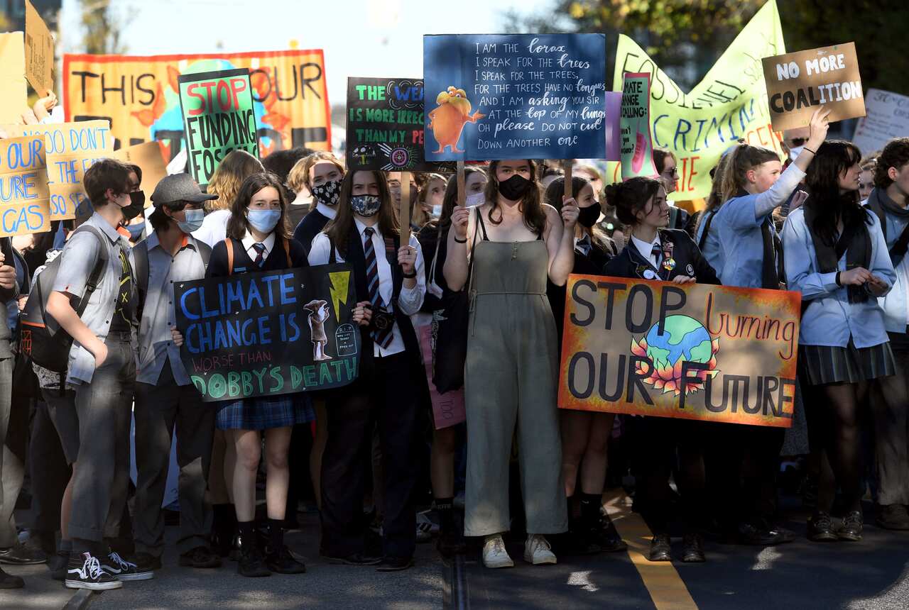 Students march at a School Strike 4 Climate rally during a mass school strike for climate action in Melbourne on May 21, 2021.