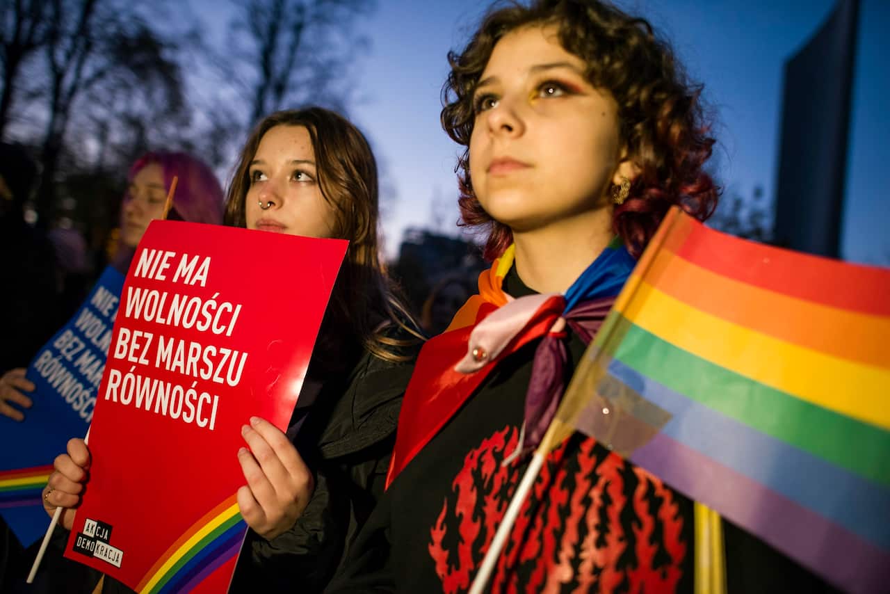 People gathered outside the Polish Parliament in Warsaw to protest against a law proposal that would put a total ban on equality marches.