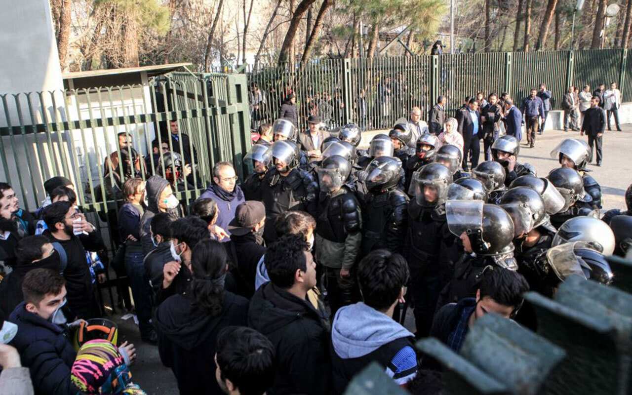 Iranian students scuffle with police at the University of Tehran during a demonstration driven by anger over economic problems, in the capital Tehran.