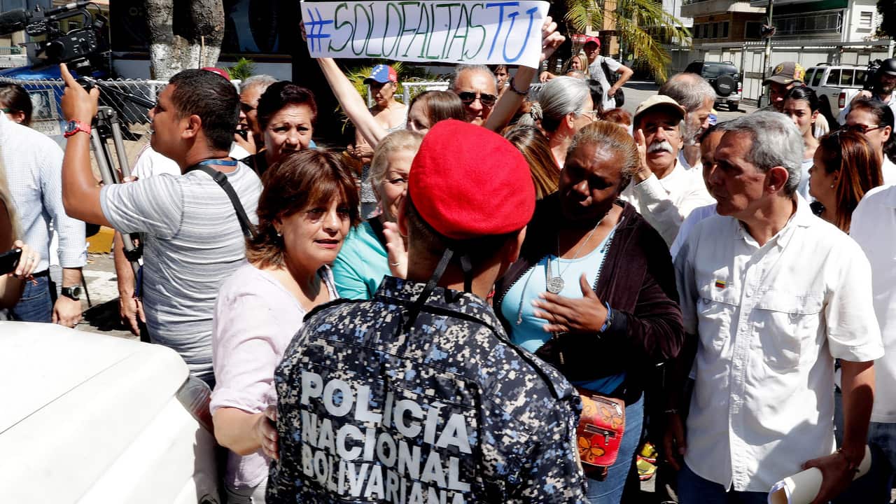 Members of civil society arrive at the control post of the presidential residence, known as La Casona, to deliver the Amnesty Law, in Caracas, Venezuela.