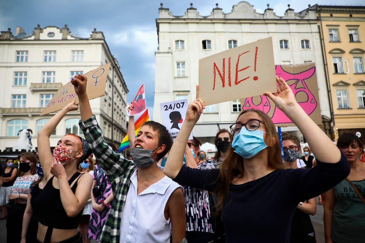 People wear protective face masks during an anti-domestic violence protest at the Main Square in Krakow, poland on July 25, 2020.