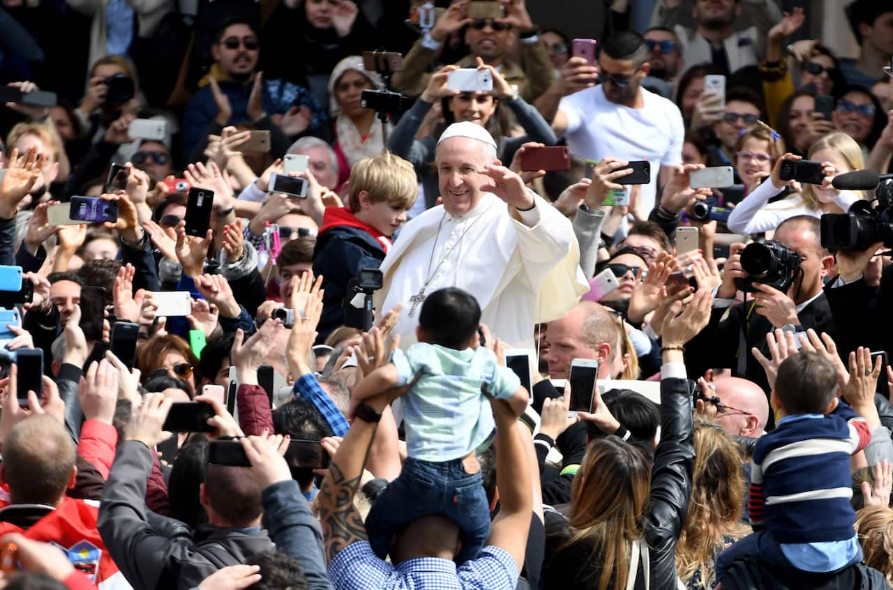 Pope Francis waves to the crowd after the celebration of the Easter Mass in St. Peter's Square at the Vatican. 