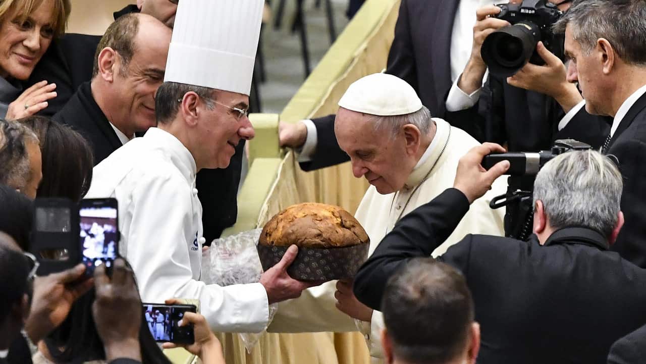 Pope Francis sniffs a Panettone, (traditional Christmas cake) on the occasion of the weekly general audience in the Paul VI hall.
