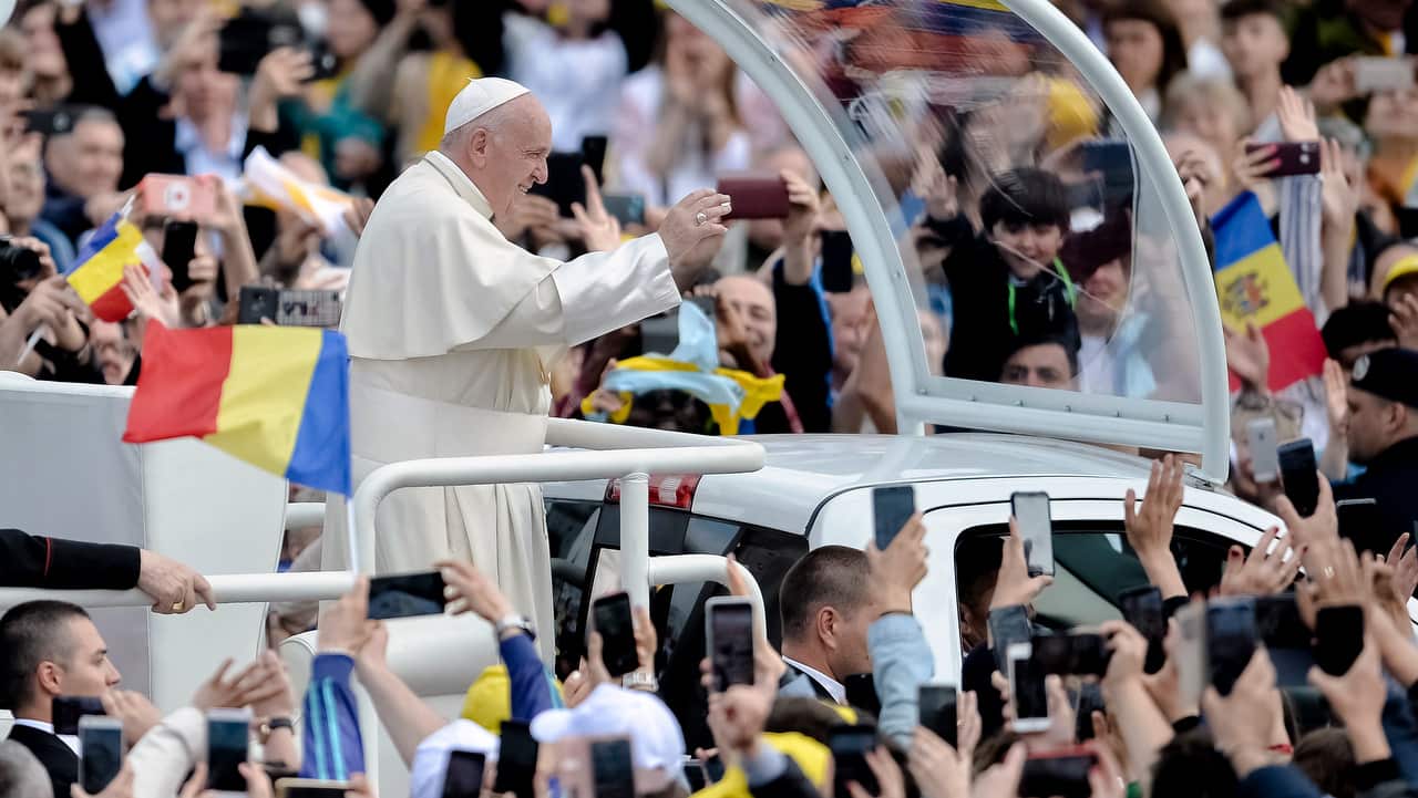 Pope Francis waves to people gathered to greet him, in Iasi, Romania.
