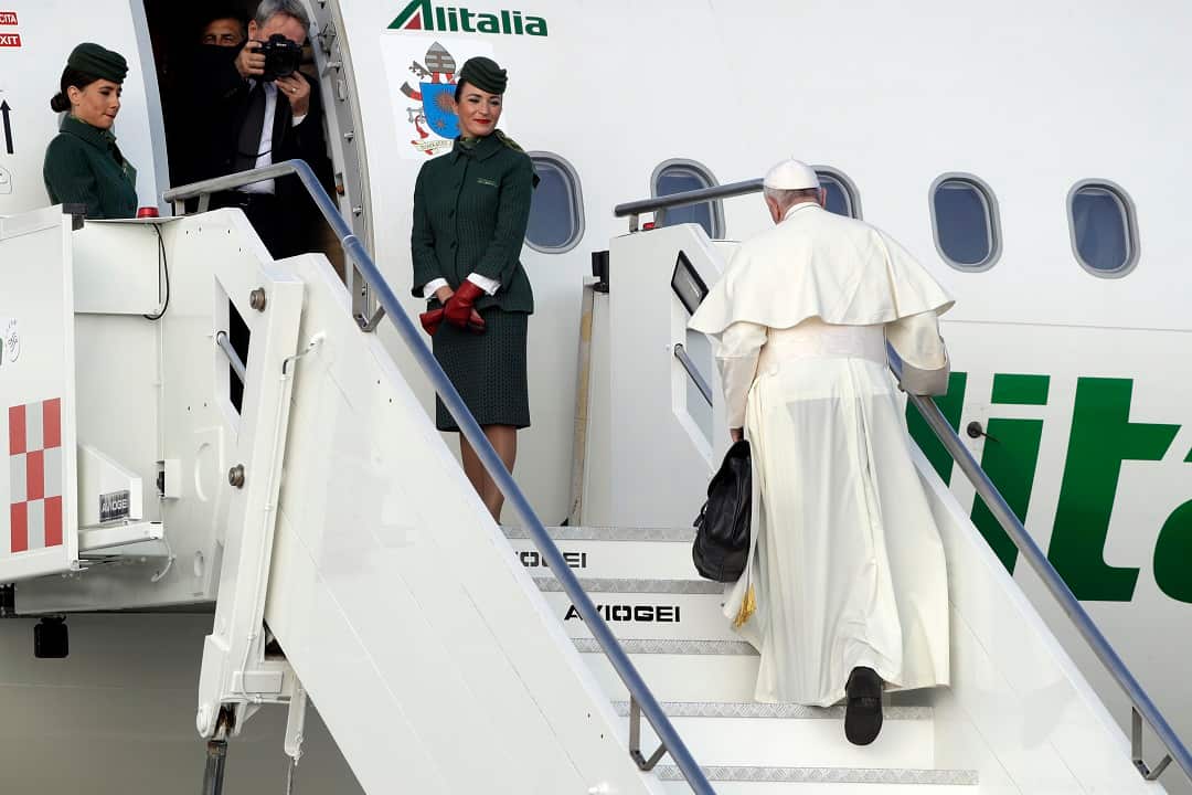 Pope Francis boards a plane en route to Ireland.