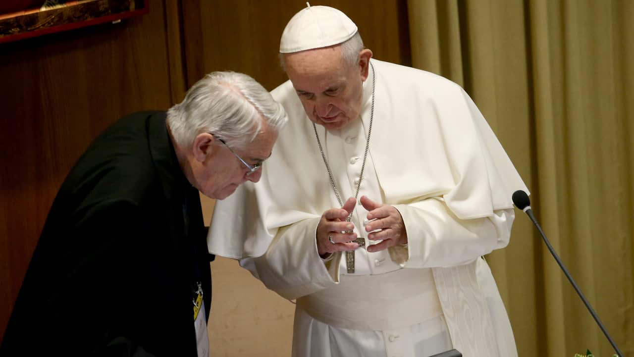 Pope Francis talks with Italian priest Federico Lombardi (moderator of the summit).