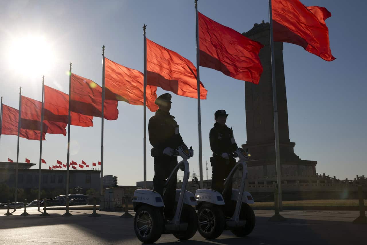 Chinese police officers patrol on motorized platforms on Tiananmen Square, Beijing, China, March, 2017