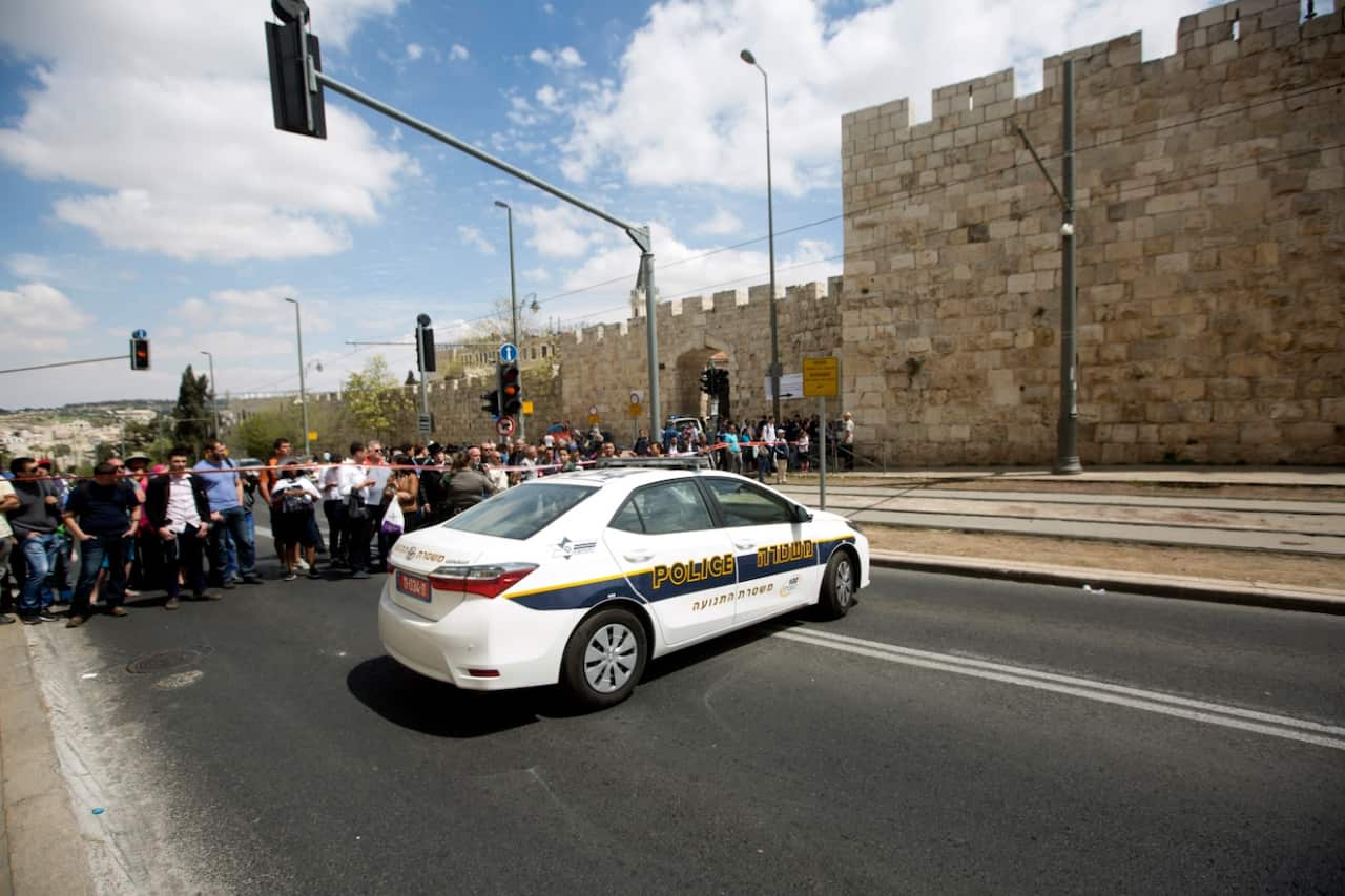 Israeli Police block the road lead to the scene of a stabbing attack that toke place in Jerusalem light rail (AAP)