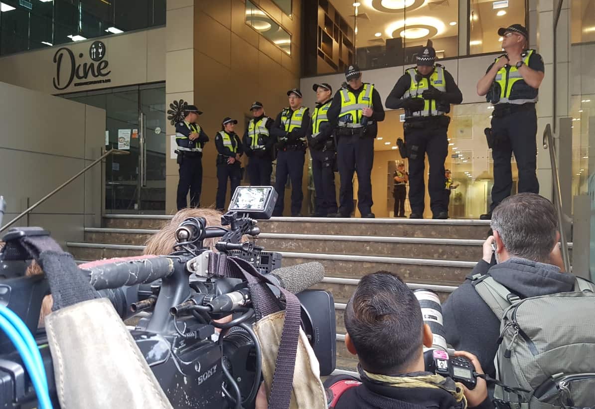 Police are seen stranding guard at the entry to the barrister's chambers before Cardinal George Pell arrived (AAP)