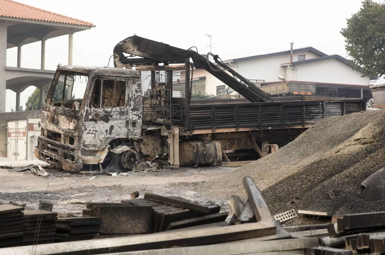 A burnt out lorry next to one of the companies destroyed by the fire in Oliveira do Hospital, central Portugal, 16 October 2017 (AAP)