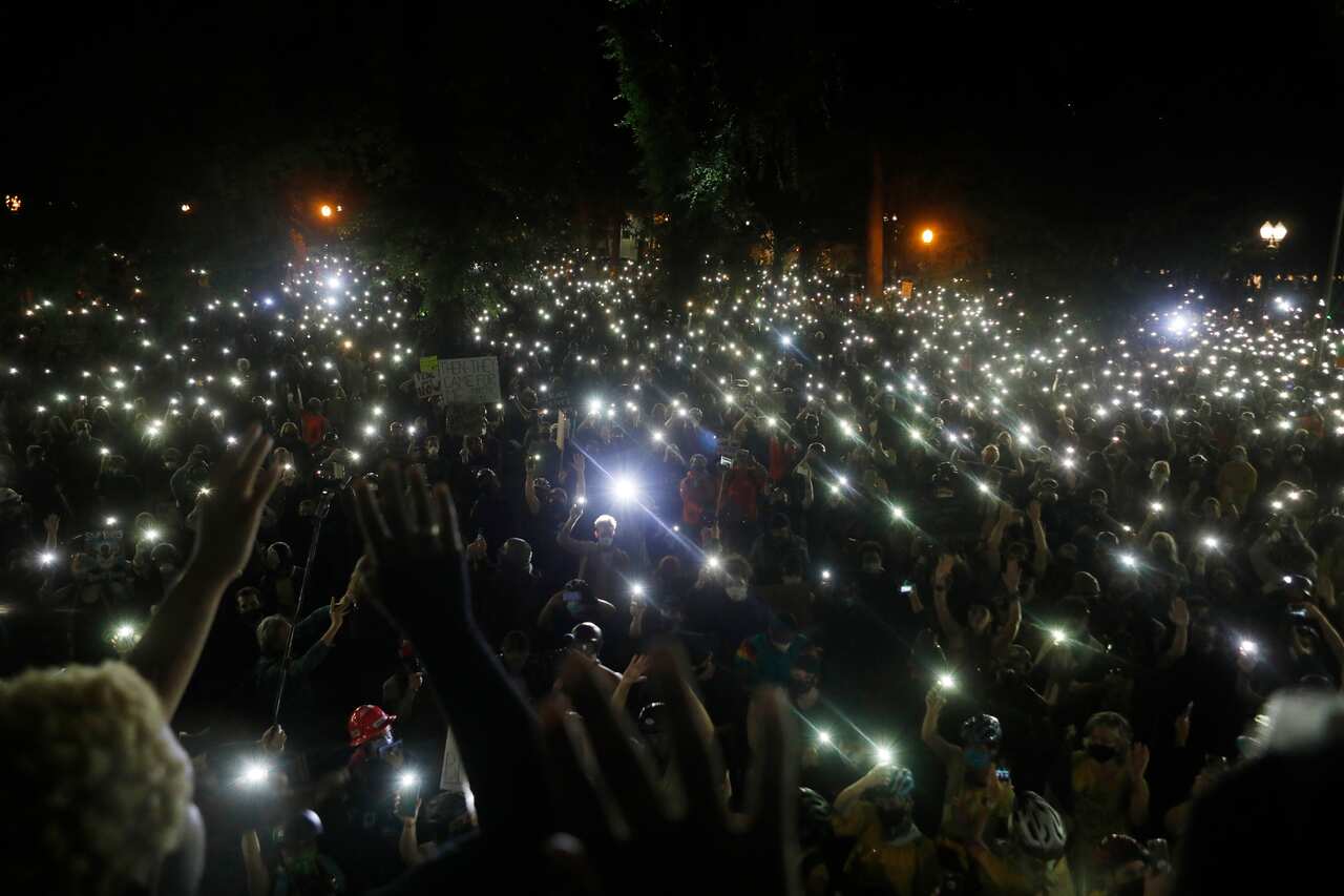 People gather in protest against inequality and racial injustice near the federal courthouse in Portland, Ore., early Thursday evening, July 23, 2020. (Octavio Jones/The New York Times)
