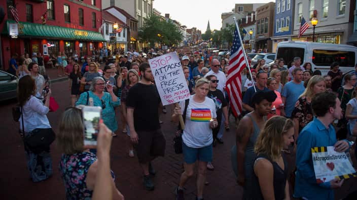 Thousands of people march during a candle light vigil to remember the five journalists from The Capital newspaper.