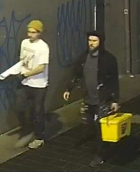 Police have released images of two men wanted in connection with offensive slogans pasted up in Tony Abbott's electorate. 