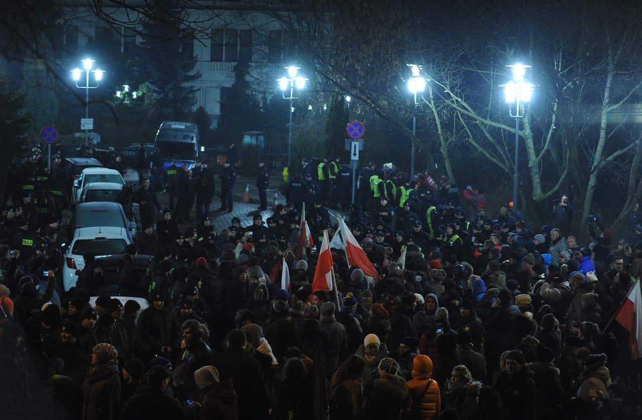 People block the exit of the Sejm (Parliament) during a demonstration organized by the Polish Committee for the Defence of Democracy (KOD) (AAP)