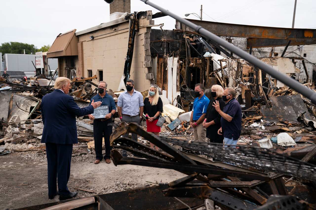 President Donald Trump speaks with business owners