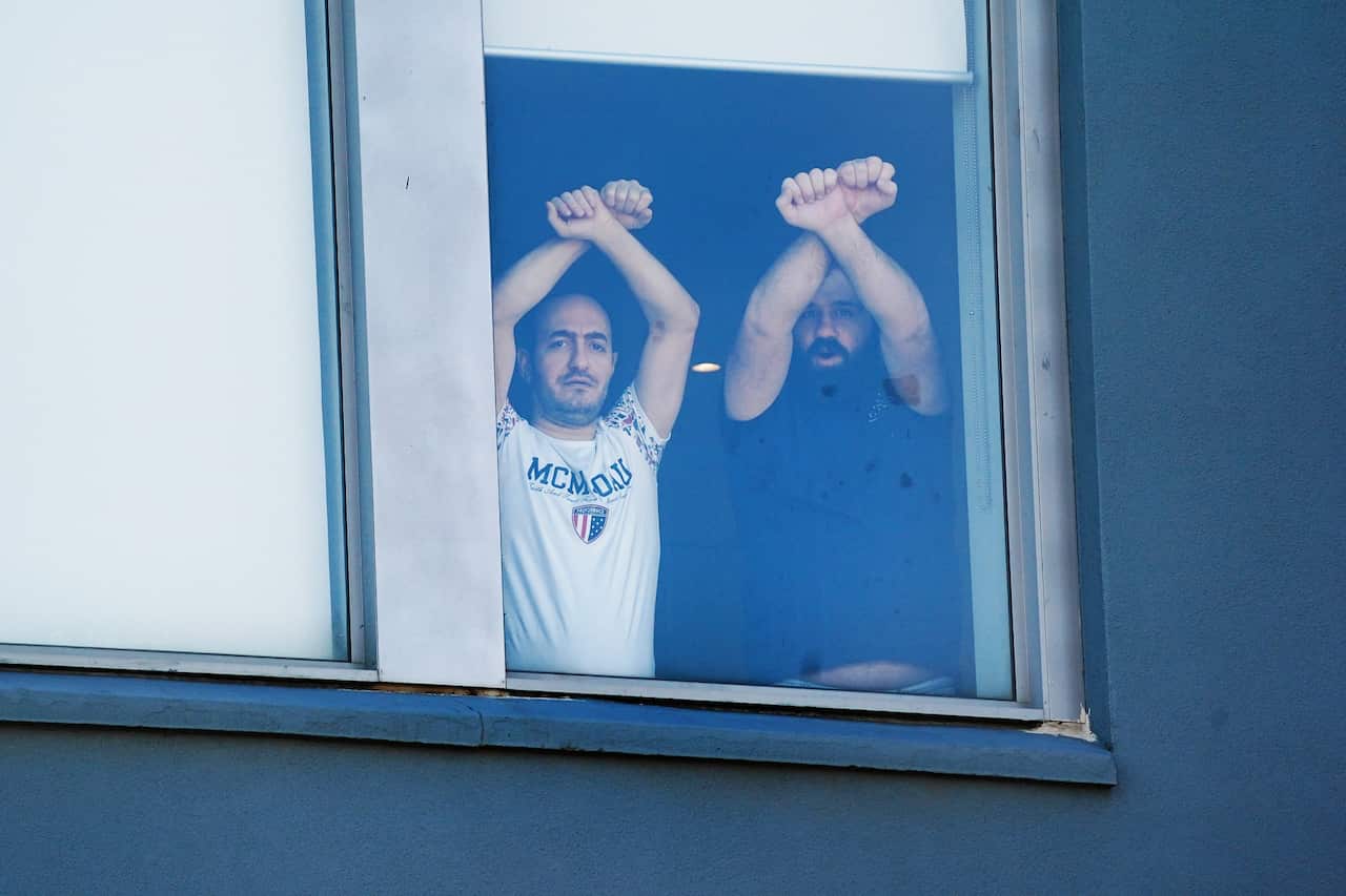 Asylum seekers protest inside the Mantra Hotel in Preston, Melbourne.