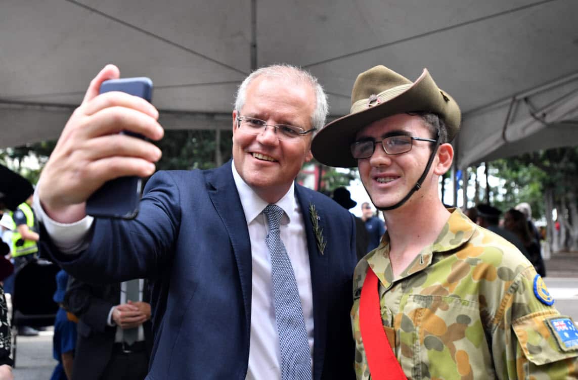 Prime Minister Scott Morrison takes a selfie at the Anzac Day march in Townsville Thursday, April 25, 2019 (AAP)
