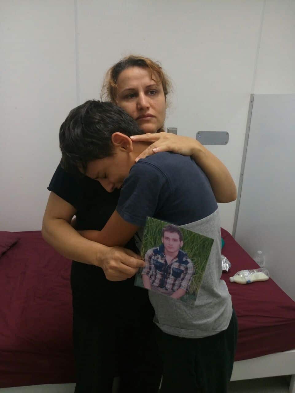 Fazileh Mansour Beigi and her son Ali grieve for Fariborz Karami. 