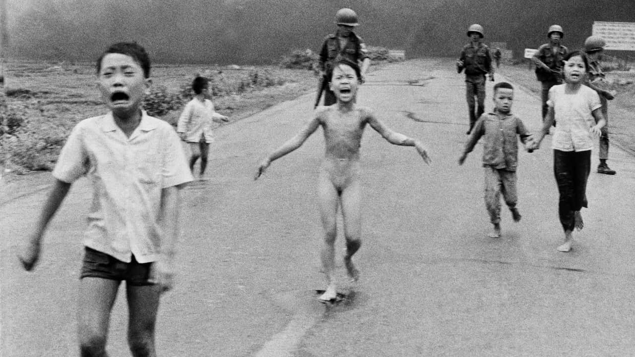 In this prize-winning photo dated June 8, 1972 a nine-year-old Kim Phuc and her relatives flee in the wake of an aerial napalm attack.