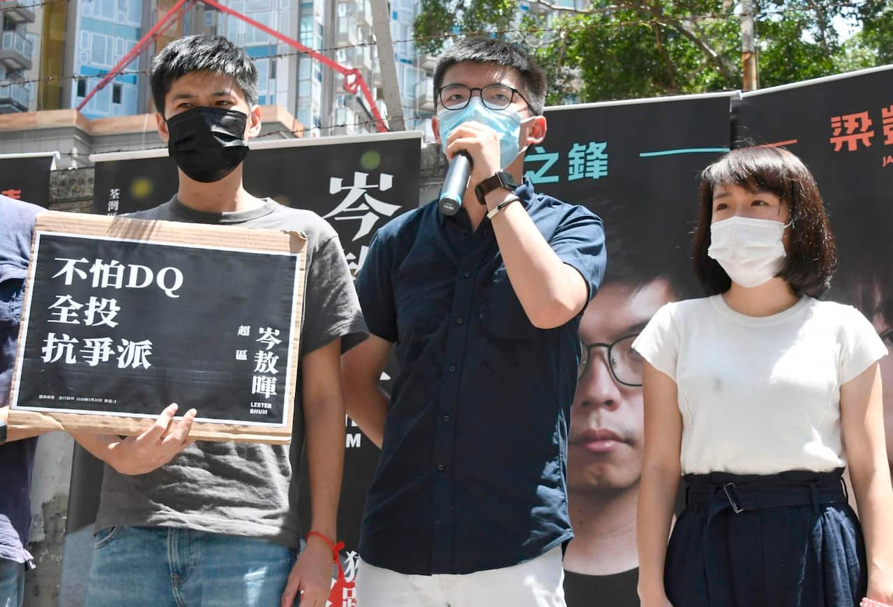 Pro-democracy activist Joshua Wong (C) makes a speech on a street in Hong Kong (AAP)