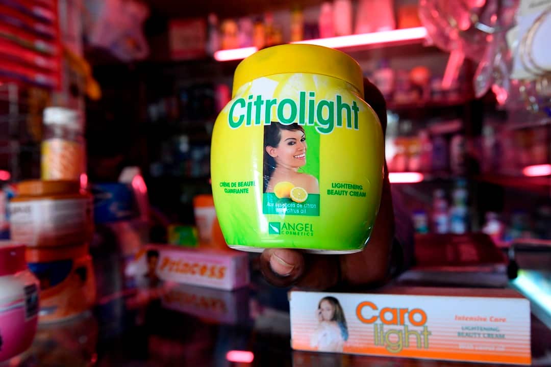 A beautician displays products used for skin lightening at a beauty shop, in Nairobi.