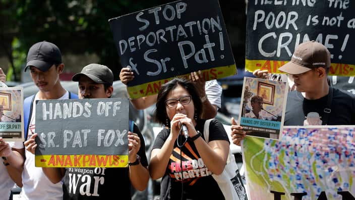 Supporters of Australian Catholic nun Sister Patricia Fox shouts slogans outside as they hold a rally outside the Bureau of Immigration in Manila.