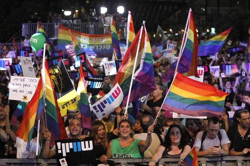 People rally during a demonstration for gay rights in front of the Rabin square in Tel Aviv, Israel. New laws have banned gay men from surrogacy.