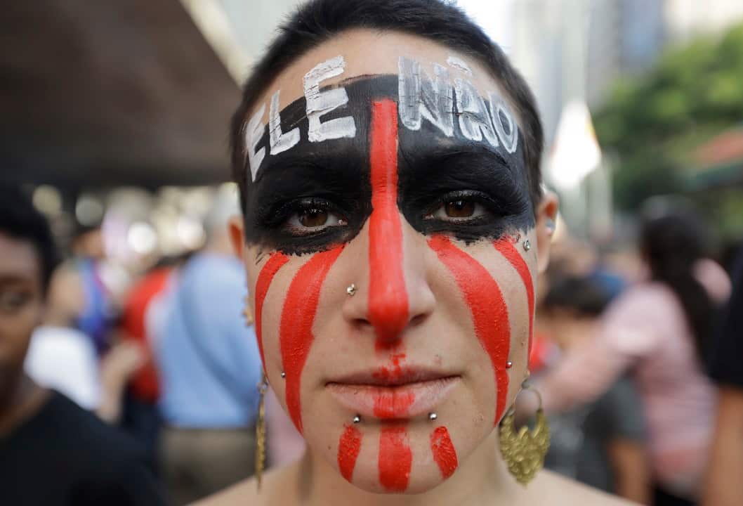 A woman with the words "Not him" written in Portuguese on her forehead during a protest against Jair Bolsonaro.