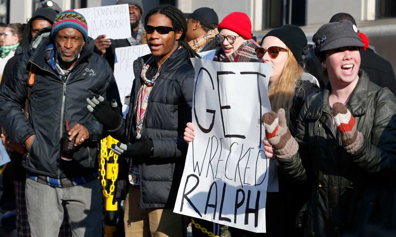 Demonstrators hold signs and chant outside the Governors office at the Capitol in Richmond, Va., Saturday, Feb. 2, 2019. 