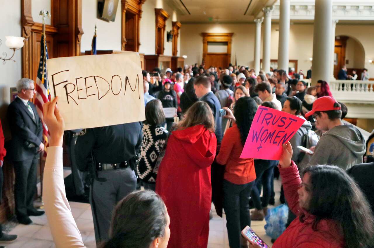 Protesters opposed to a proposed abortion bill fill the hallway on Monday, March 18, 2019, in Atlanta. 