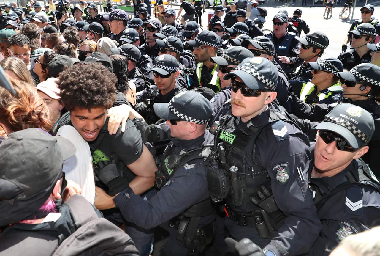 Protesters attempt to stop conference members entering during a protest against The International Mining and Resources Conference in Melbourne.