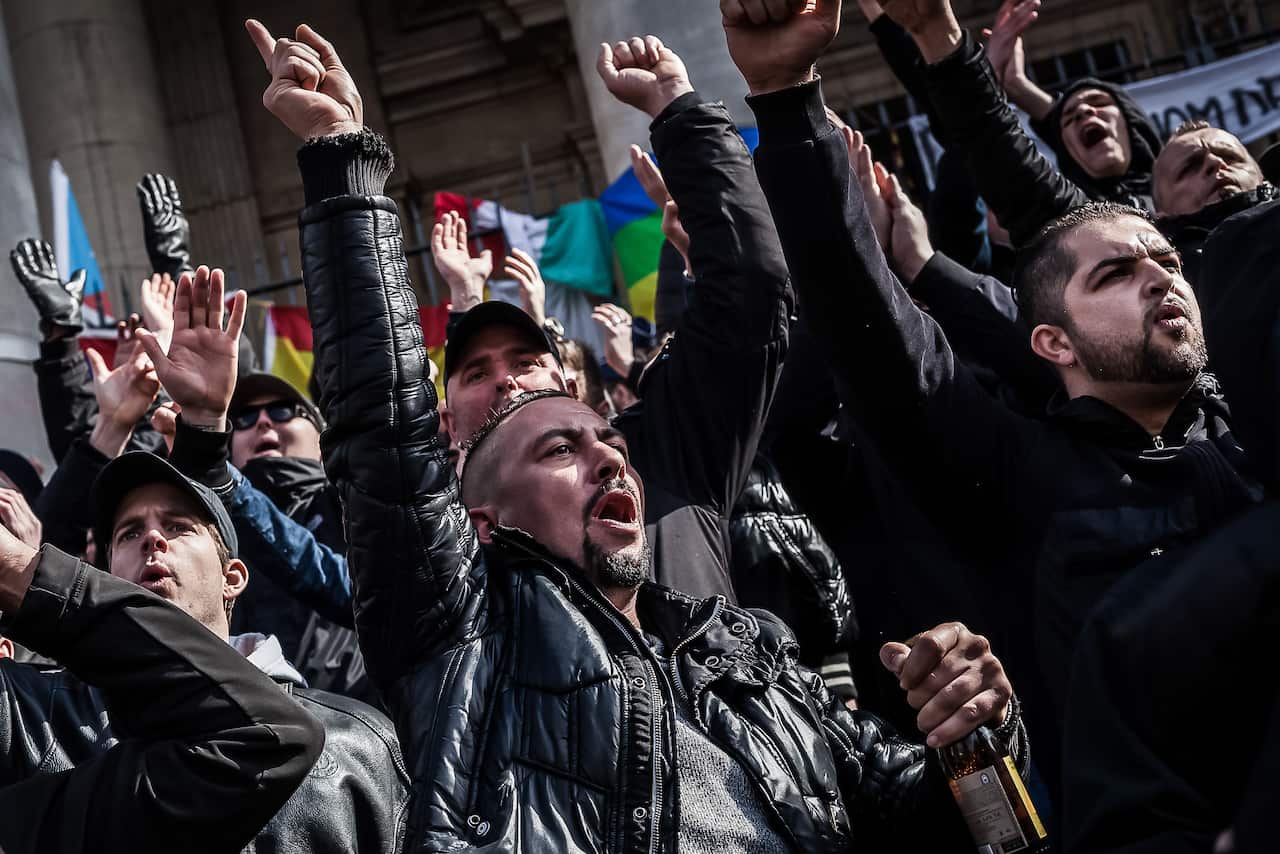 Demonstrators protest at a memorial site at the Place de la Bourse in Brussels (AAP)