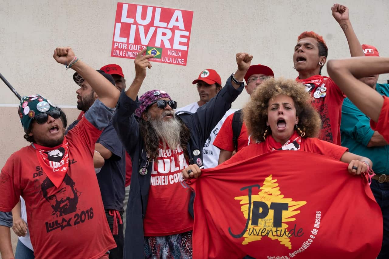 Supporters of Brazil's former President Luiz Inacio Lula da Silva shout "Free Lula" outside the Federal Police headquarters 