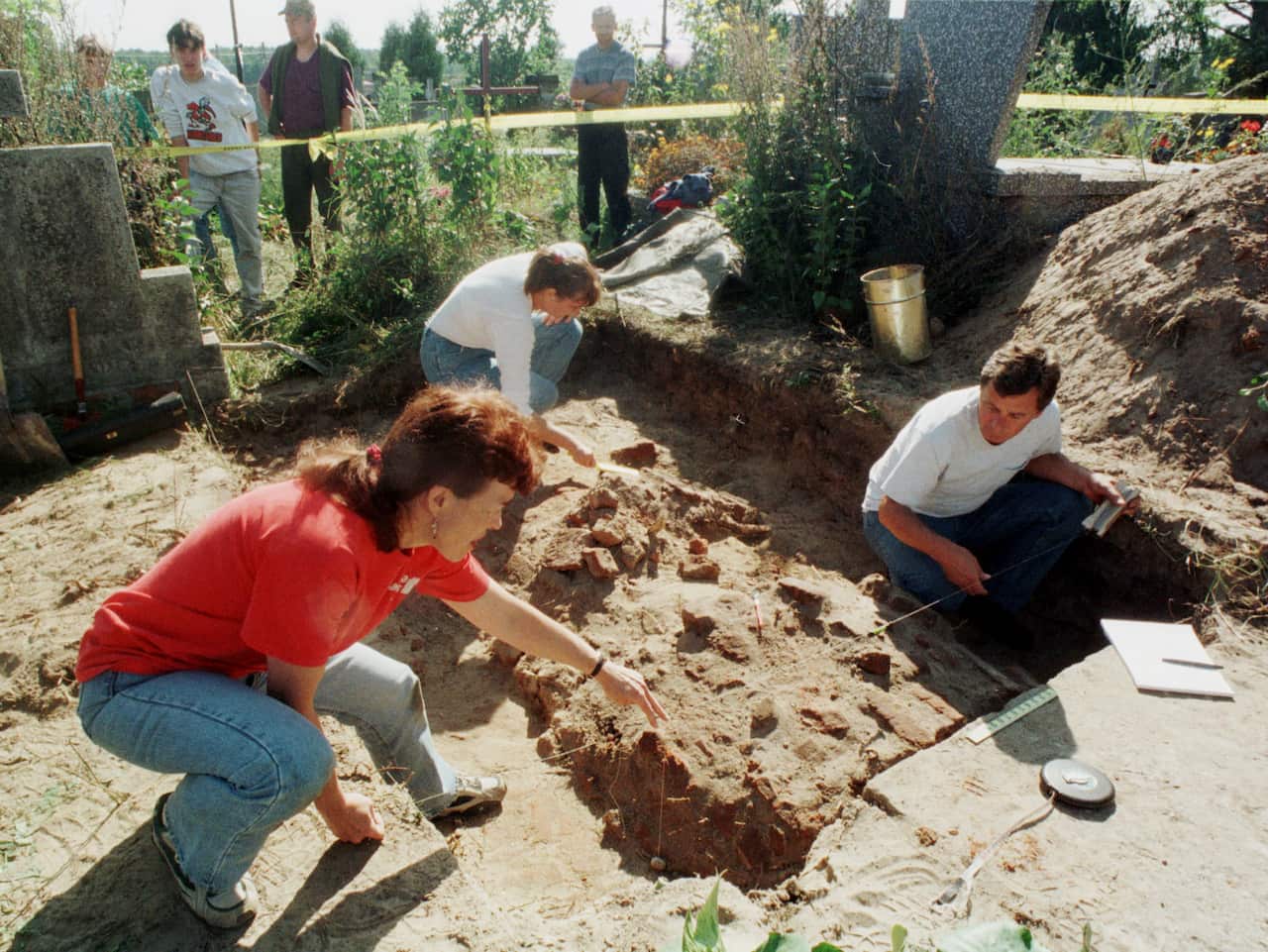 Forensic experts work during exhumation of Pulaski's great grandniece, Theresa Witkowska, as part of the investigation.