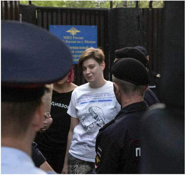 Olga Pakhtusova, a member of the feminist protest group Pussy Riot, is led out of jail and into a police van in Moscow.