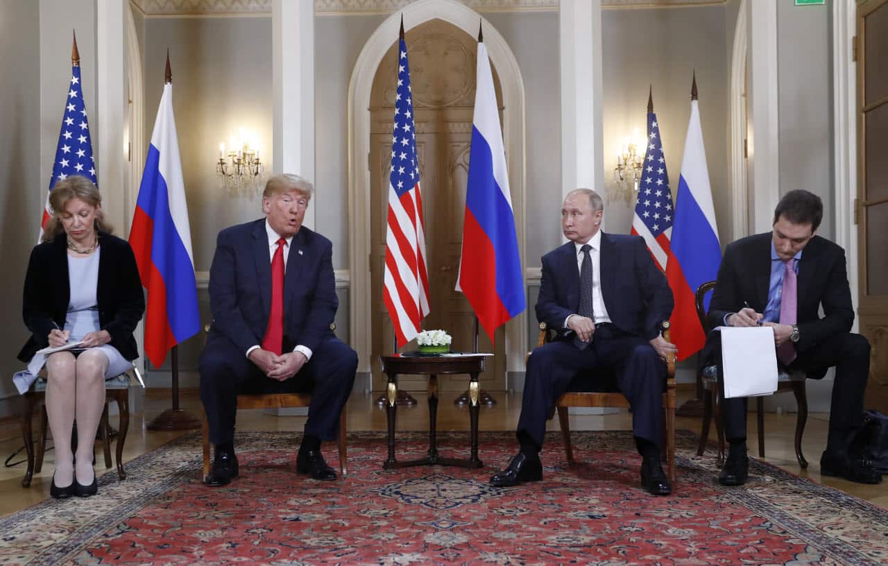 US President Donald Trump gives a statement as Russian President Vladimir Putin looks on.