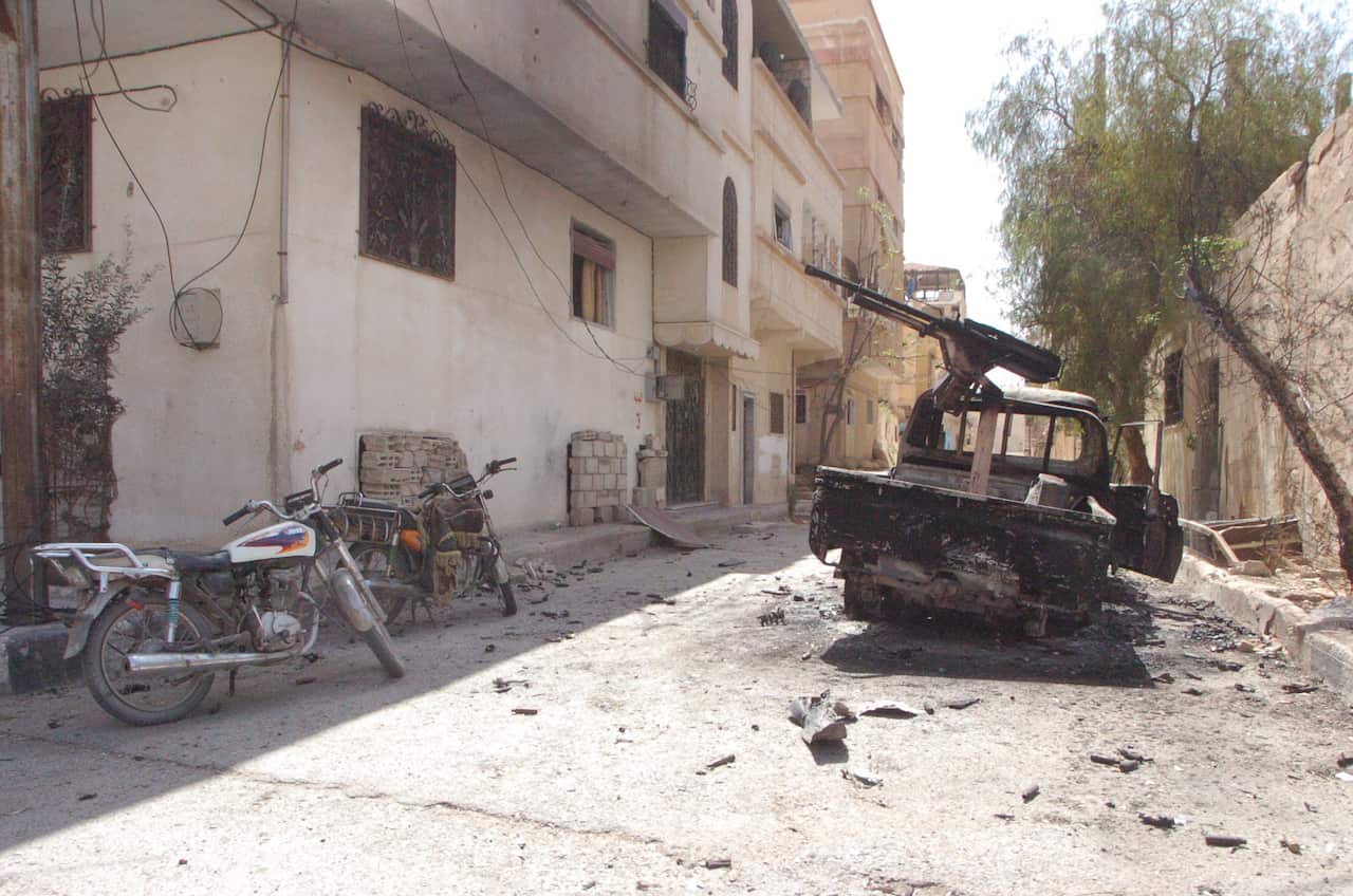A torched machinegun-loaded vehicle is seen at one of the streets of the ancient city of Palmyra