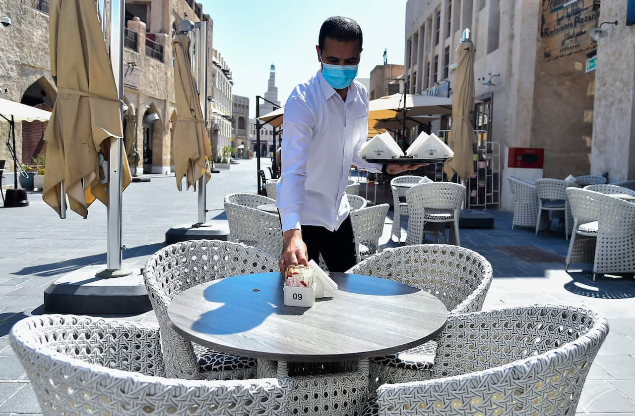 A waiter at a restaurant in Qatar